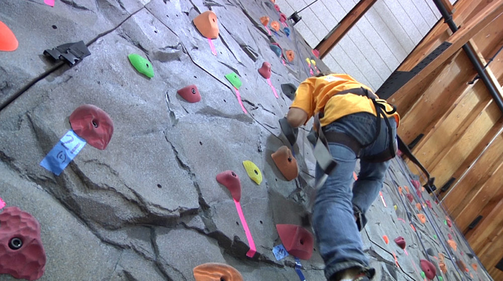 A Boys and Girls Club member tries climbing for the first time.