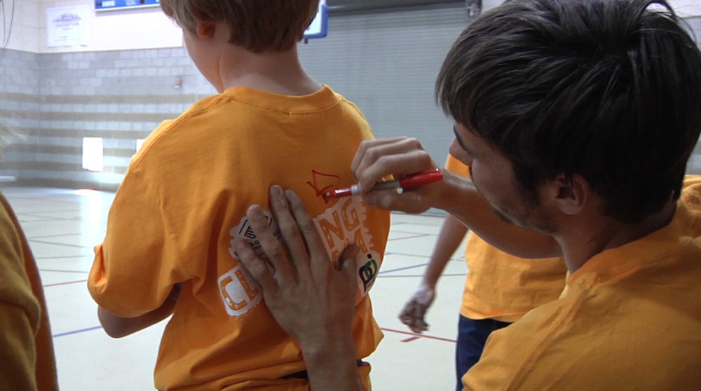 Kevin Jorgeson signs a BGC member's shirt.