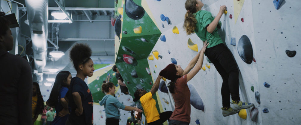 A Chicago Boys and Girls Club member is aided by staff of First Ascent in Chicago.