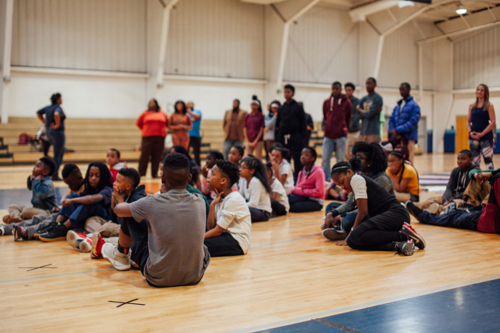 A few boys and girls club members hang out before the wall opening.