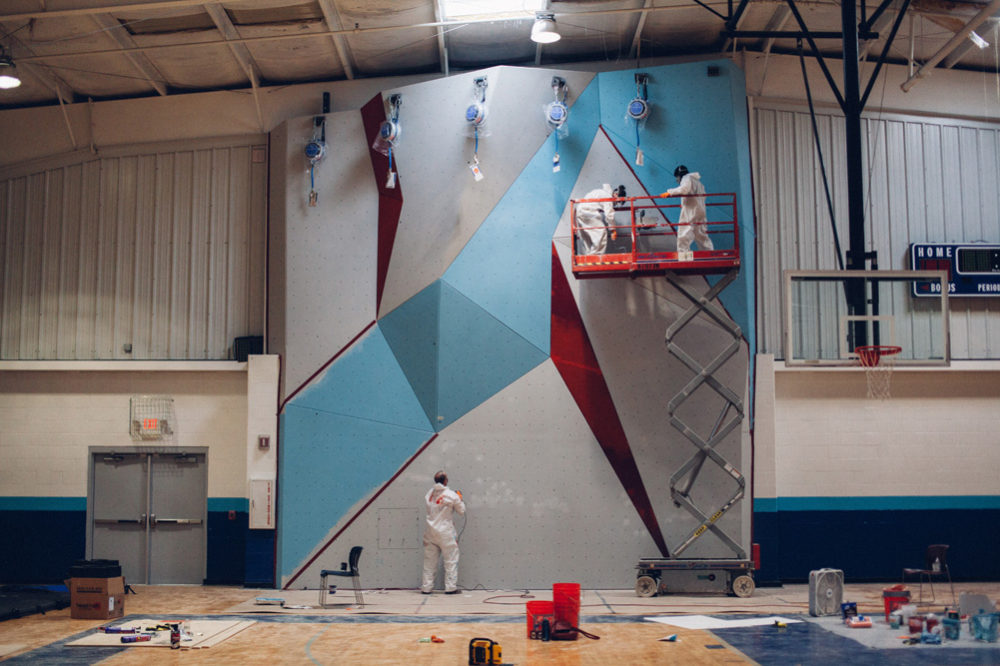 Eldorado Climbing Walls staff paint and sand the wall.