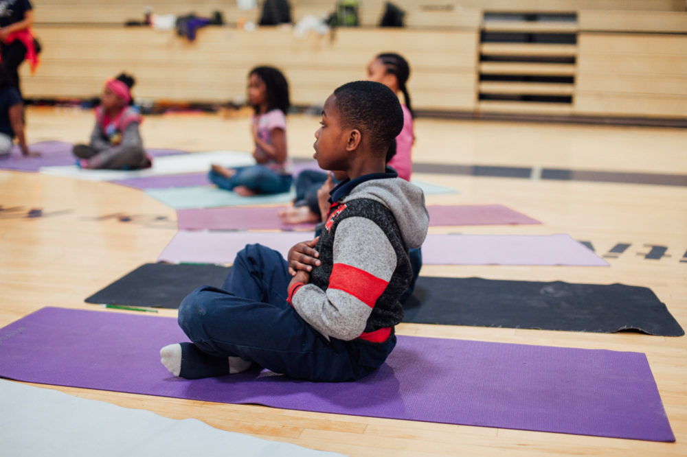 Saint Louis Boys and Girls club members try yoga for the first time.