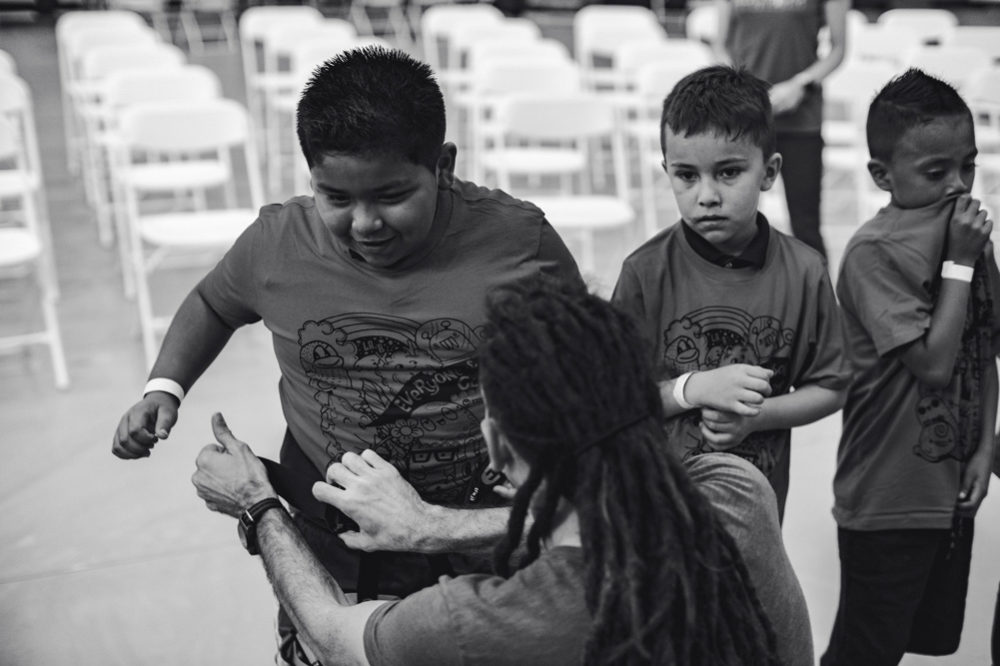 Dave Chancellor of So iLL, help LA Variety Boys and Girls Club members with their harnesses.