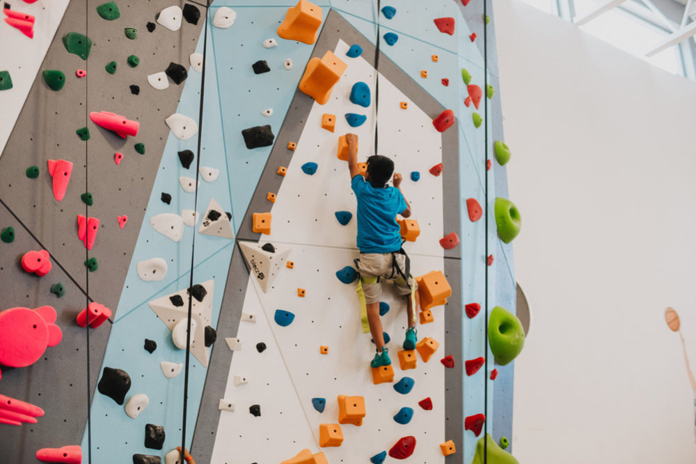 LA Variety Boys and Girls Club member Climbing up a So iLL 