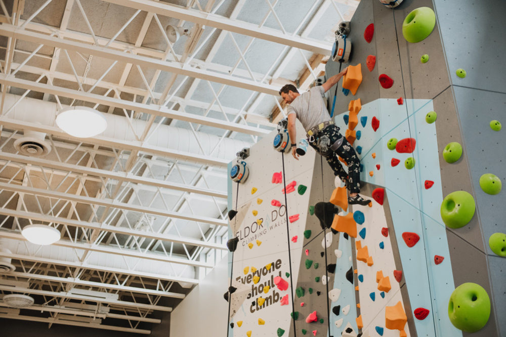 TOMS founder, Blake Mycoskie tries out the new LA Variety Boys and Girls Club wall.