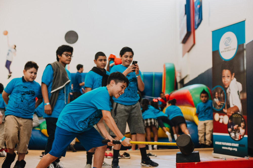 LA Variety Boys and Girls Club members play games during the grand opening of the new climbing wall.