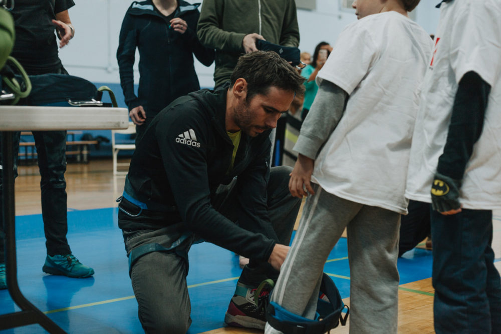 1climb co founder kevin jorgeson helps a boys and girls club member try on a harness