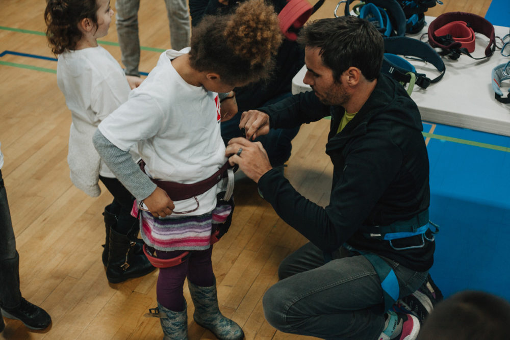 1climb co founder kevin jorgeson helps a boys and girls club member try on a harness