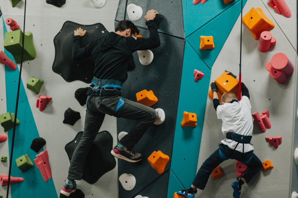 1 climb co founder kevin jorgeson helps a boys and girls club member climb up the new 1climb wall in santa rosa