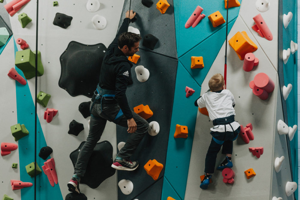 1 climb co founder kevin jorgeson helps a boys and girls club member climb up the new 1climb wall in santa rosa