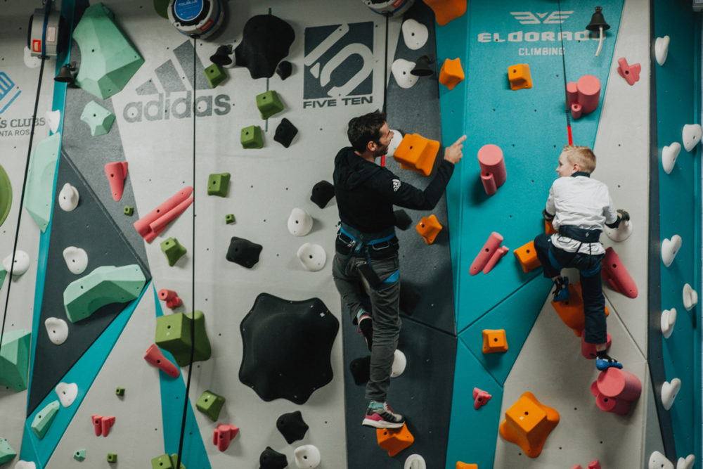 1 climb co founder kevin jorgeson helps a boys and girls club member climb up the new 1climb wall in santa rosa