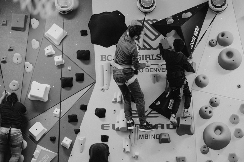 Climber and 1Climb cofounder Kevin Jorgeson helps a Boys and Girls club up the newly constructed Denver 1Climb wall